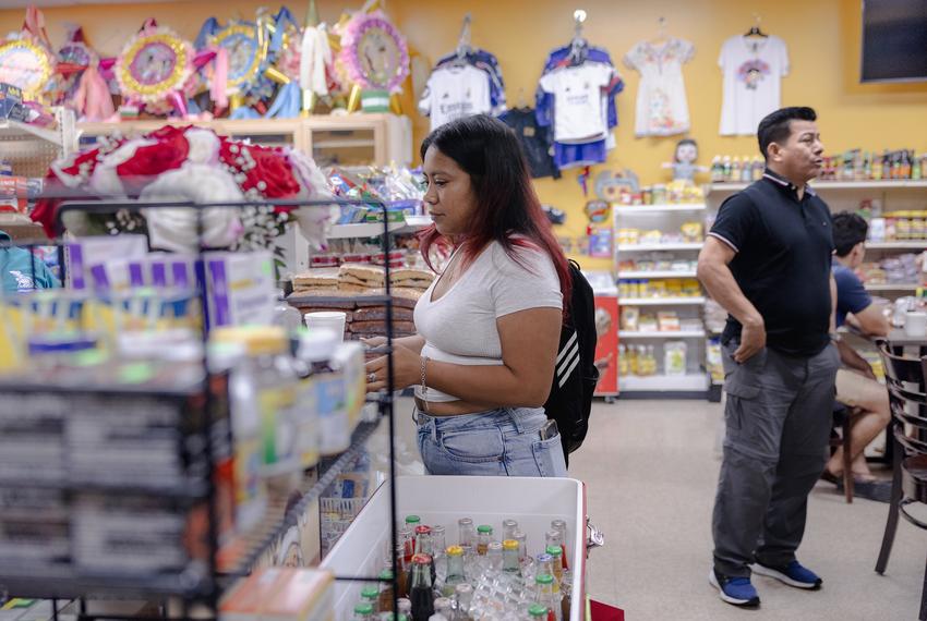 Lisbet Avila buys breakfast at a local spot, Friday, May 30, 2025, in Houston.(Lexi Parra for The Texas Tribune)